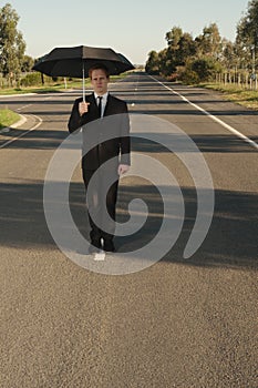 Businessman with umbrella face