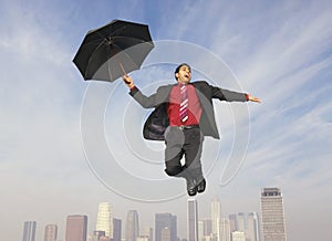 Businessman With An Umbrella In Midair