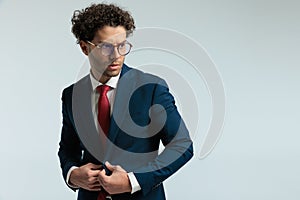 businessman unbuttoning his suit with aggressiveness