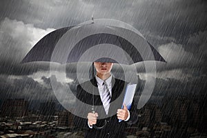 Businessman under heavy rain