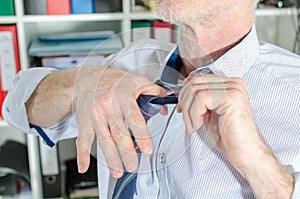 Businessman undoing his tie