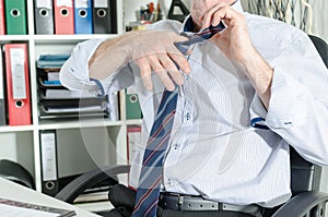 Businessman undoing his tie