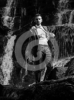 businessman undressing at waterfall ready to swim. business trip. summer vacation traveling. agile business. agine