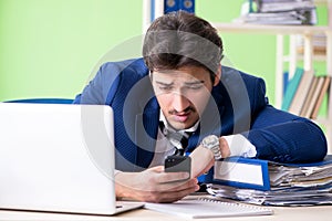 The businessman unhappy with excessive work sitting in the office