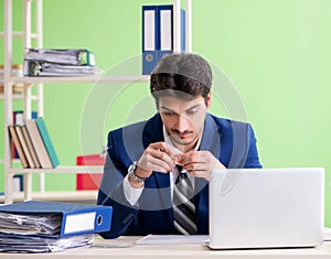 Businessman unhappy with excessive work sitting in the office