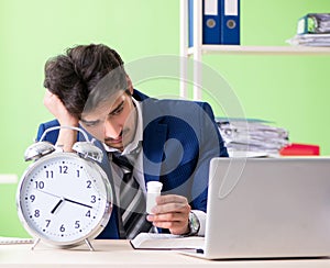 Businessman unhappy with excessive work sitting in the office