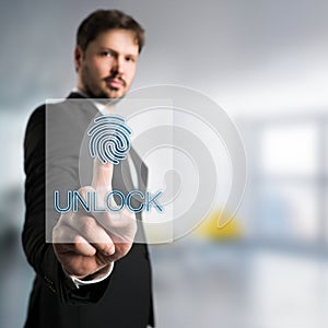 Businessman unlocking an interface with fingerprint