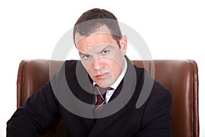 Businessman upset seated on a chair