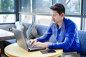 Businessman use labtop in the coffee shop and tablet is on the table