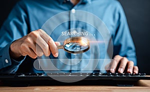 Businessman use magnifying glass Search On Virtual Screen Data Search Technology Search Engine Optimization. Man use computer to
