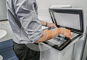 Businessman use printer to scan important and confidential documents in office