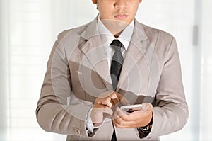 Businessman use a smartphone in office.