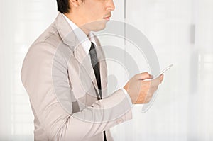 Businessman use a smartphone in office.