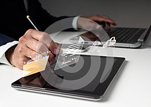A businessman uses a pen to sign an e-document on a virtual notepad on a virtual screen. E-signing, electronic signature, document