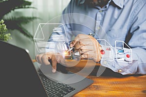 Businessman uses a pen to sign an electronic signature approved on an electronic document with a laptop on a wooden table.