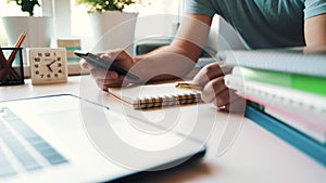 Businessman uses a smartphone and laptop in the office at the workplace.