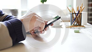 Businessman uses a smartphone in the office at the workplace.