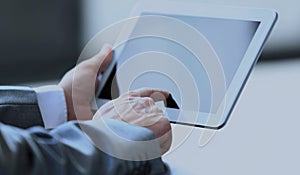 Businessman uses the tablet in a modern office