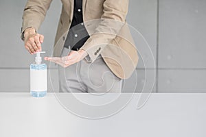 Businessman using  alcohol gel or antibacterial soap sanitizer washing hands