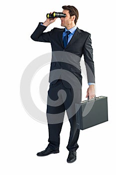 Businessman using binoculars while holding a briefcase