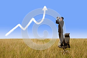 Businessman using binoculars looking growth graph cloud