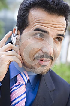 Businessman using bluetooth earpiece