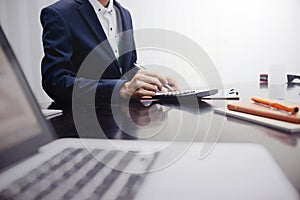 Businessman using a calculator to calculate financial accounts