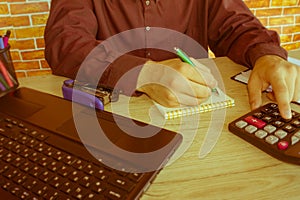 Businessman using a calculator to calculate the numbers