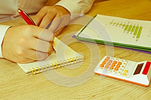 Businessman using a calculator to calculate the numbers. Businessman calculate finance and thinking about problem