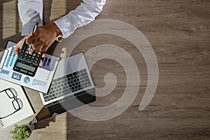 businessman using a calculator top view, calculating user expenses, budgeting, and loan accounting