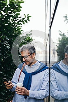 Businessman using cellphone outdoor