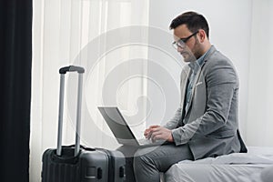 Businessman using computer on a business trip. Traveling for work.