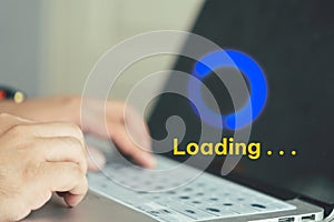 Businessman using computer keyboard with virtual loading icon