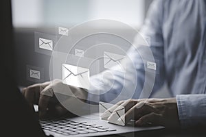 Businessman using computer laptop to send many e-mail and business newsletter to customers for online digital marketing concept