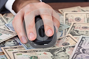 Businessman Using Computer Mouse On Banknotes