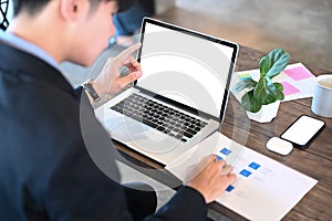 A businessman using computer tablet browsing financial website for checking banking exchange