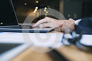 Businessman using computer to analyse data.