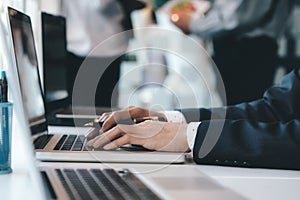 Businessman using computer to analyse the investment.