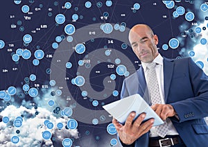 Businessman using digital tablet against cloud computing background