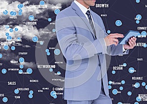 Businessman using digital tablet against cloud computing icons