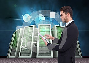 Businessman using digital tablet against server room and graph chart background