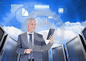 Businessman using digital tablet against server systems in sky