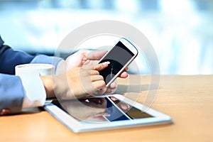 Businessman using digital tablet computer with modern mobile phone