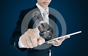 Businessman using digital tablet and pressing unlock icon on screen