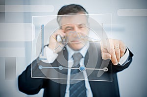 Businessman using futuristic touchscreen to view graph