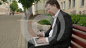 Businessman using his laptop to purchase something online with his credit card