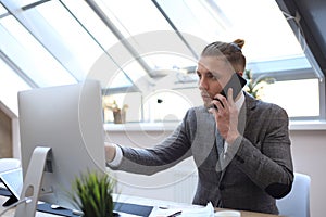 Businessman using his mobile phone in the office