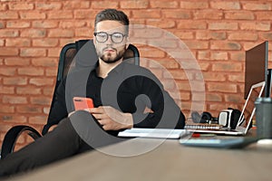 Businessman using his mobile phone in the office