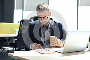 Businessman using his mobile phone in the office
