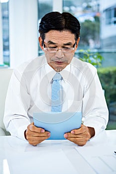 Businessman using his tablet